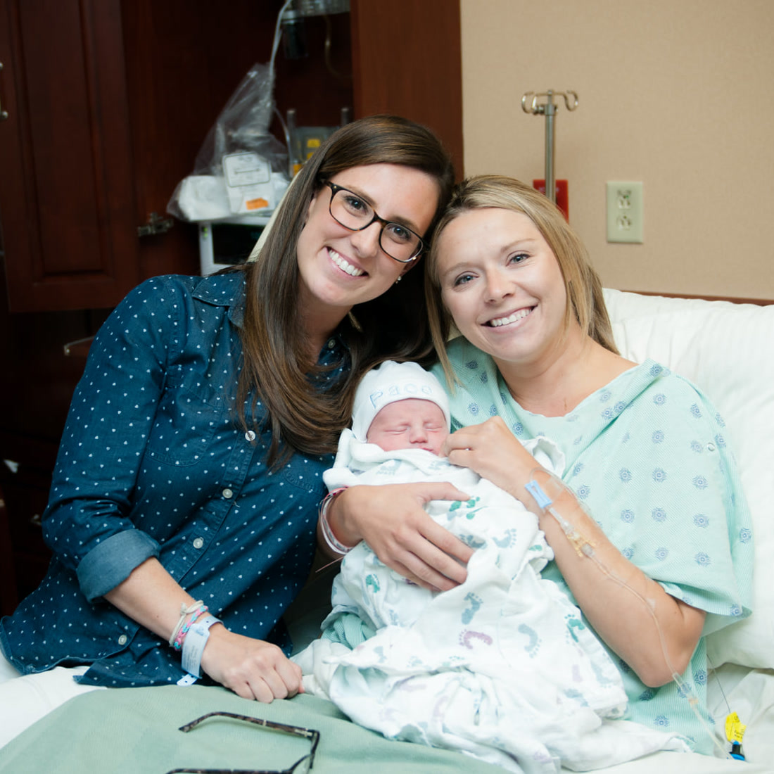 Katy with a surrogate and newborn baby in the hospital