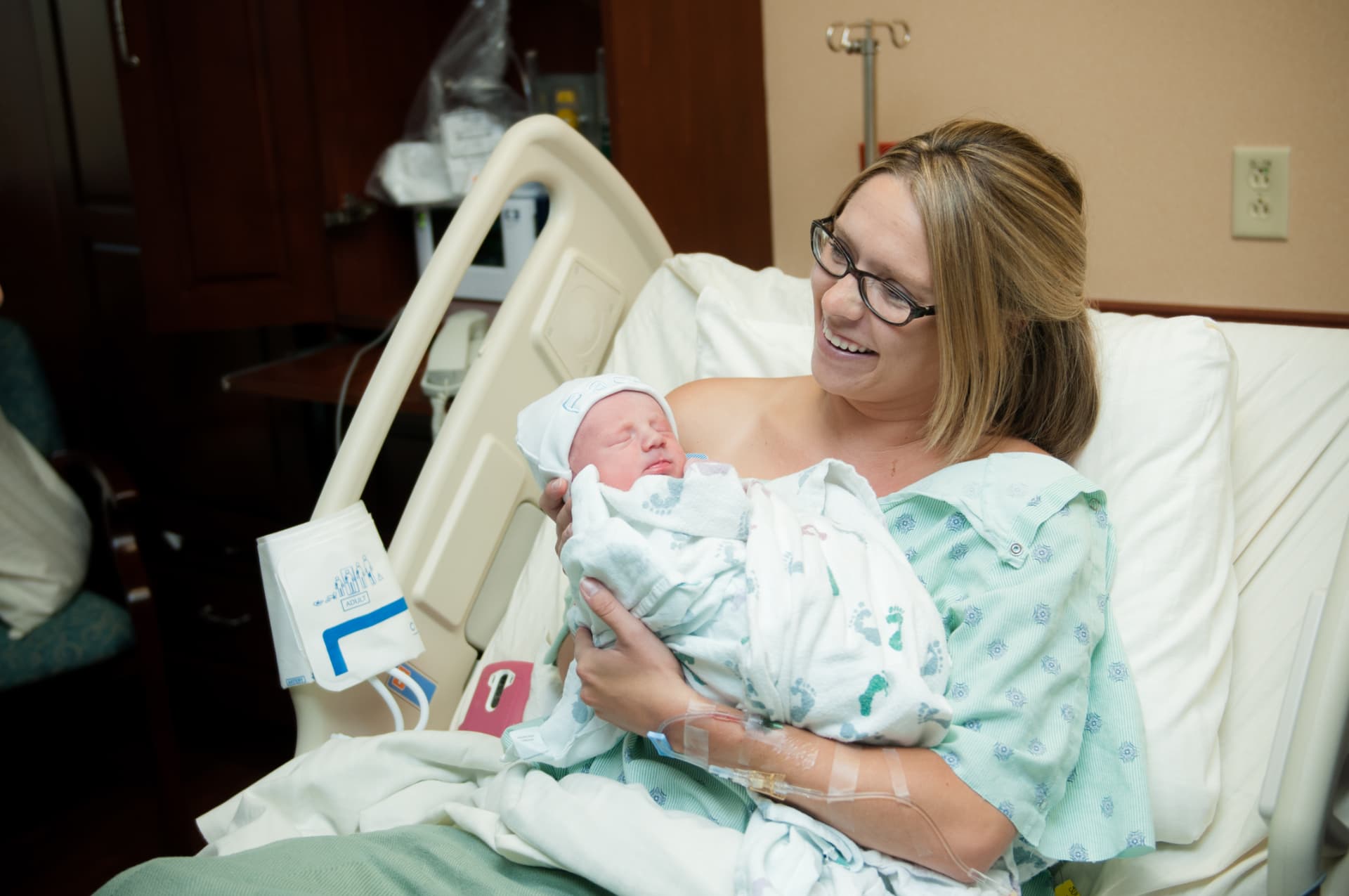 Katy holding a newborn after delivery
